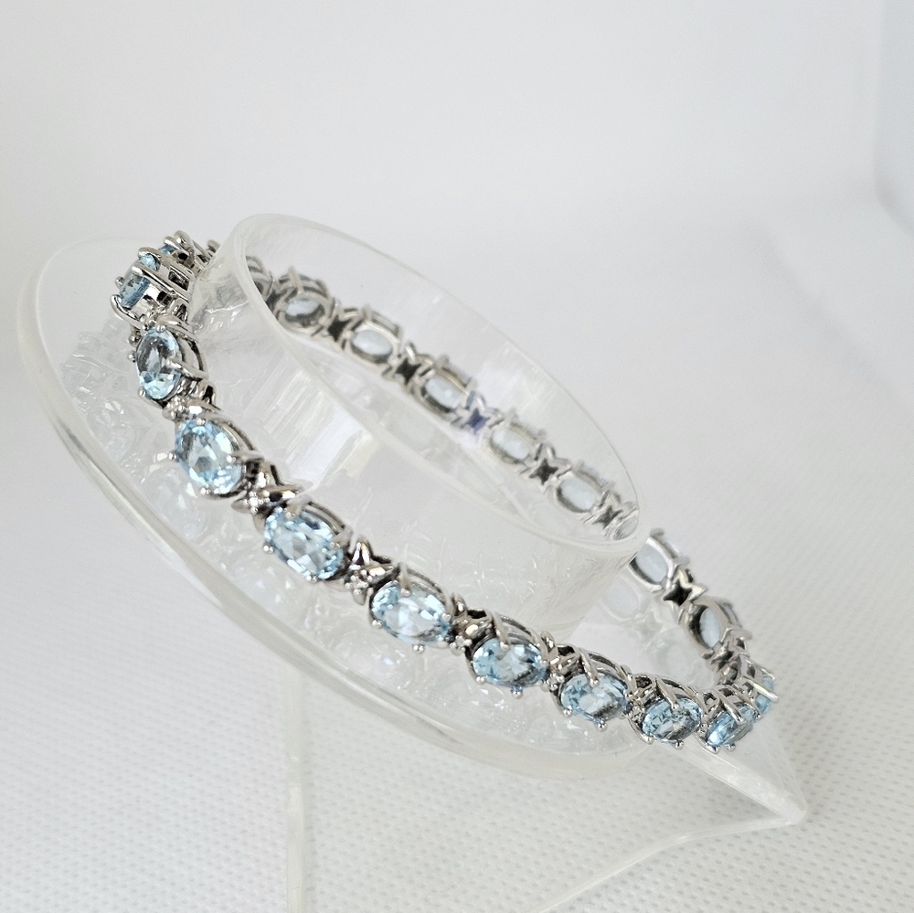 Natural Sky Blue Topaz & Diamond Accent Tennis Bracelet in Sterling Silver!